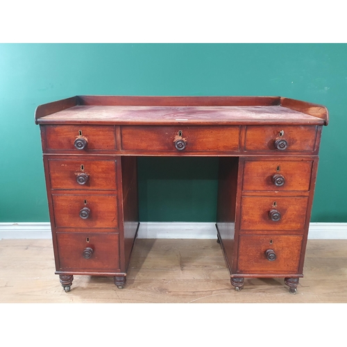 582 - A 19th Century mahogany Desk with red leather inset top fitted nine drawers on turned supports and c... 