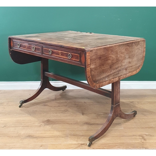 6 - A 19th Century mahogany and satinwood inlaid Sofa Table with pair of fitted drawers, raised on shape... 