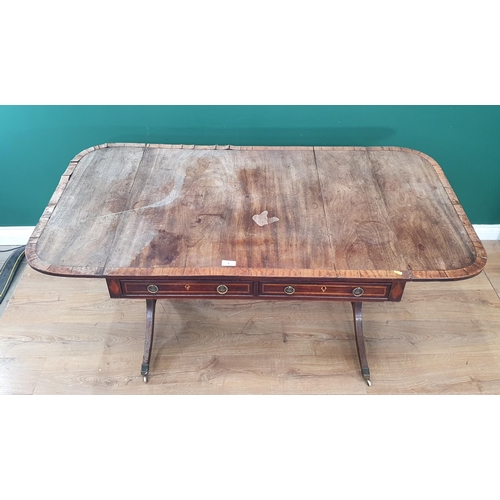 6 - A 19th Century mahogany and satinwood inlaid Sofa Table with pair of fitted drawers, raised on shape... 