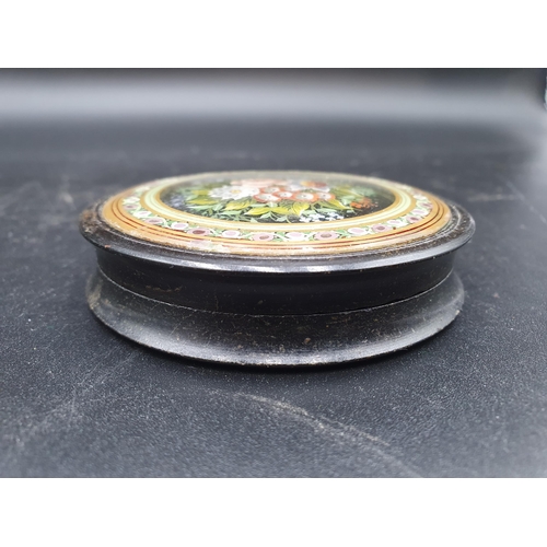 60 - A circular Trinket Box with engine turning base, the lid with floral painted glass panel, 3 1/4in