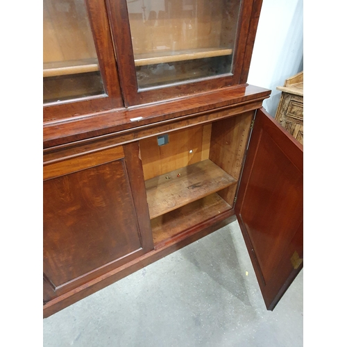 605 - A Victorian mahogany glazed Bookcase with moulded cornice above a pair of glazed panelled doors encl... 