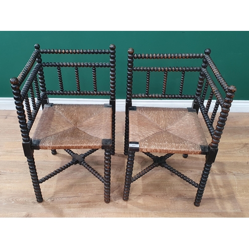 622 - A pair of bobbin turned Elbow Chairs with rush seats (R8)