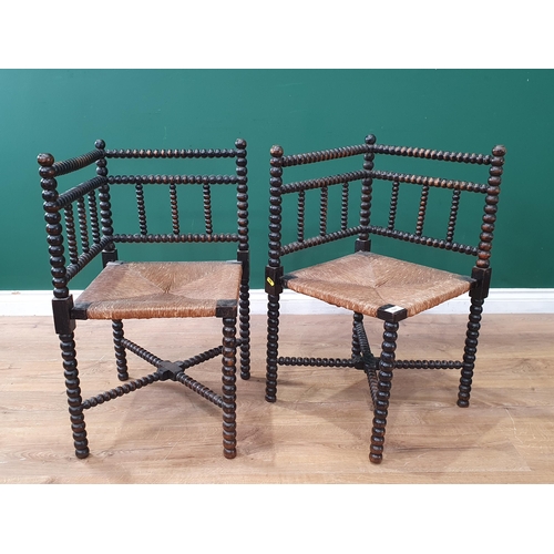 622 - A pair of bobbin turned Elbow Chairs with rush seats (R8)