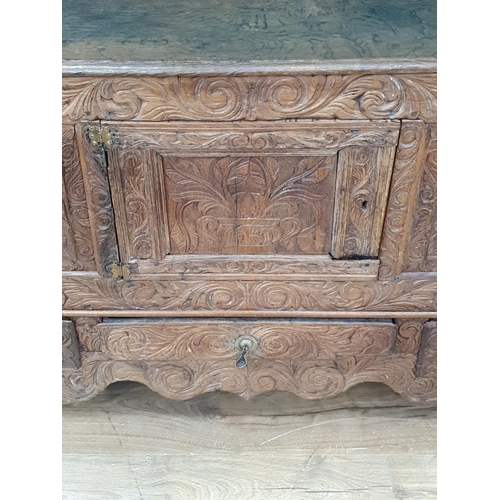 633 - An antique carved oak Mule Chest fitted two drawers 4ft 10in W x 2ft 8in H (R8)