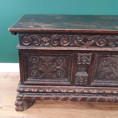 640 - A Victorian oak Blanket Chest with three leafage carved panels to front mounted on paw feet 4ft 6in ... 