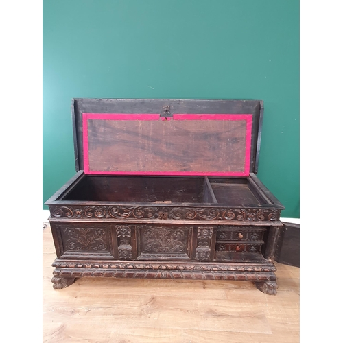 640 - A Victorian oak Blanket Chest with three leafage carved panels to front mounted on paw feet 4ft 6in ... 