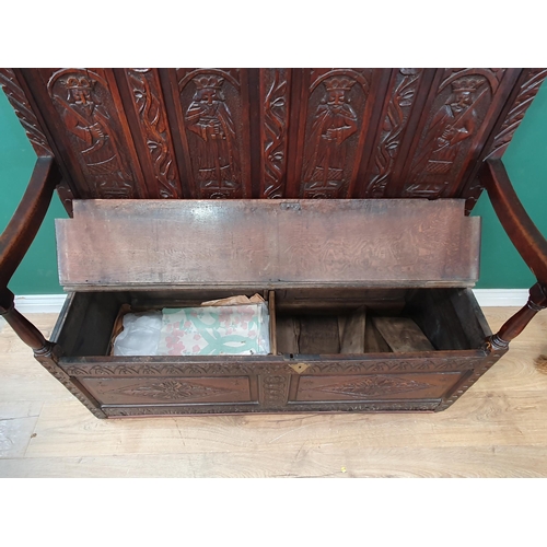 641 - A Victorian carved oak Settle with four panel back carved with warriors above box seat 4ft W x 3ft 1... 