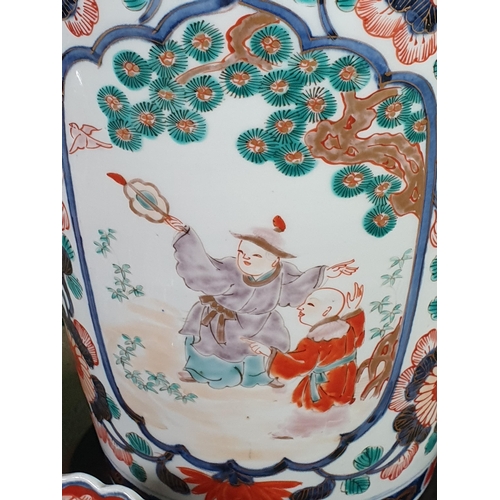 689 - A 19th Century Imari baluster Vase painted figures in shaped reserves flowering shrub surround in re... 