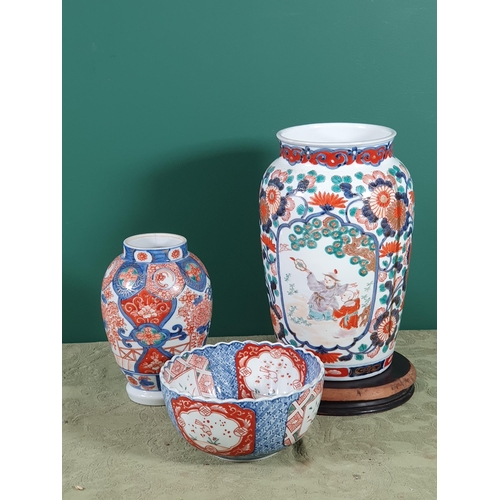 689 - A 19th Century Imari baluster Vase painted figures in shaped reserves flowering shrub surround in re... 