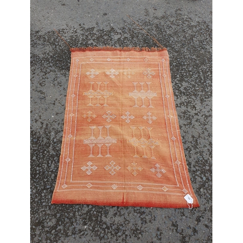 728 - A small red Rug with stylised motifs, 4ft 4in x 2ft 11in