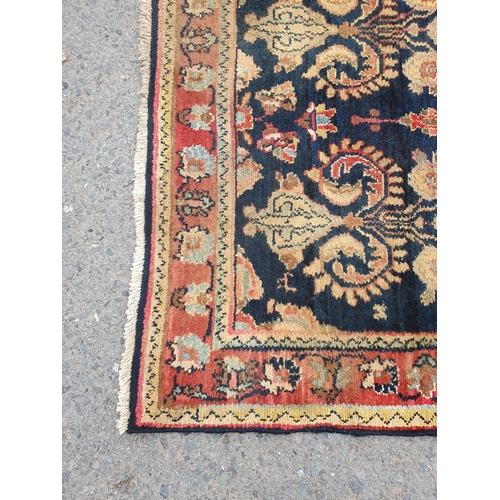 729 - A bordered Persian style Runner with floral designs on a blue ground, 10ft 7in x 3ft 10in