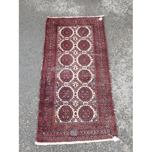 730 - A small Persian Rug with rows of medallions on a cream ground, 6ft x 3ft