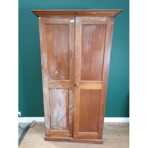 735 - An oak Estate Cabinet with panelled doors enclosing multiple adjustable shelves, 6ft 3in H x 3ft 5in