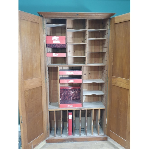 735 - An oak Estate Cabinet with panelled doors enclosing multiple adjustable shelves, 6ft 3in H x 3ft 5in