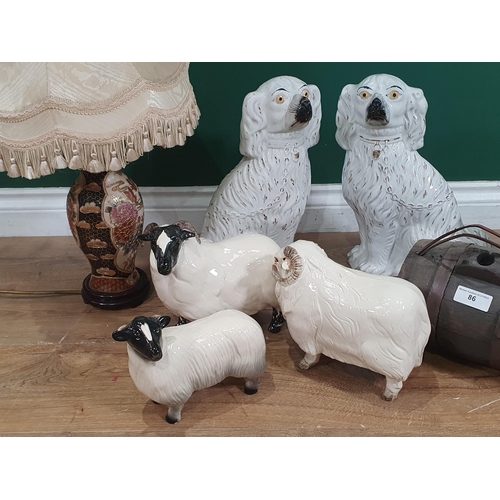 86 - Three ceramic Sheep Figures, a pair of Staffordshire seated Spaniels, a Japanese blue Vase, a Table ... 