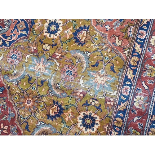 734 - A Persian Rug with floral designs to the multiple borders with central oval enclosing and surrounded... 