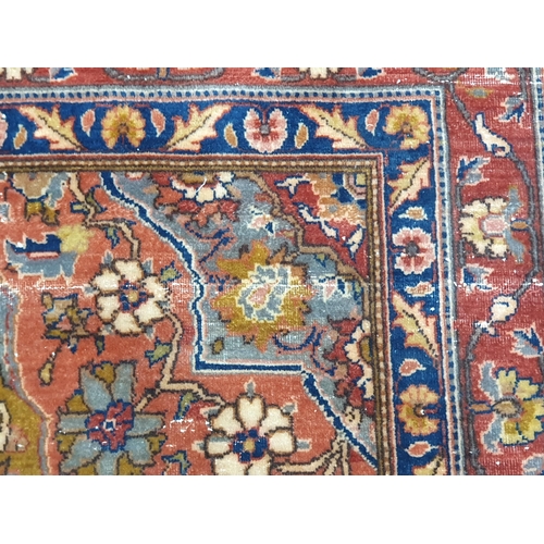 734 - A Persian Rug with floral designs to the multiple borders with central oval enclosing and surrounded... 