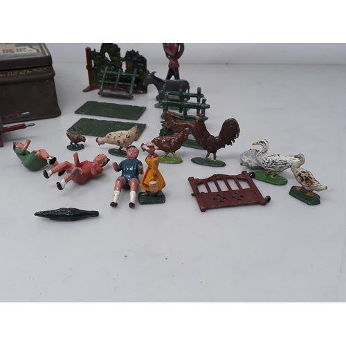 197 - A tin containing various Britains diecast Figures, Animals and Hedging