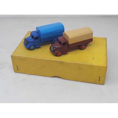 279 - A Dinky Toys No.413/30s Trade Box containing two Austin Covered Wagons