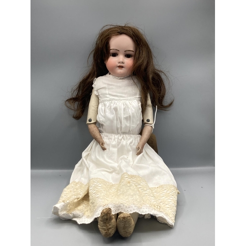 359 - A bisque headed Doll with sleeping brown eyes and kid body, 22in