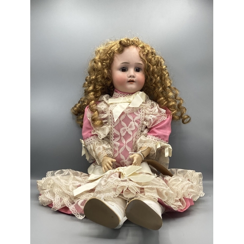 360 - A bisque headed Doll with fixed brown eyes, stamped 'Made in Germany 63', 23in