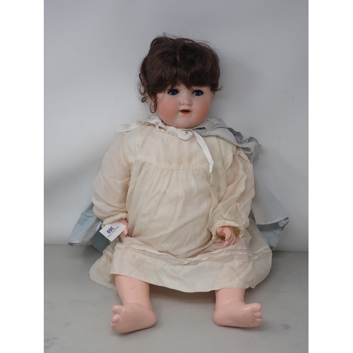 369 - An Armand Marseille 990 bisque headed Doll with fixed blue eyes 23in