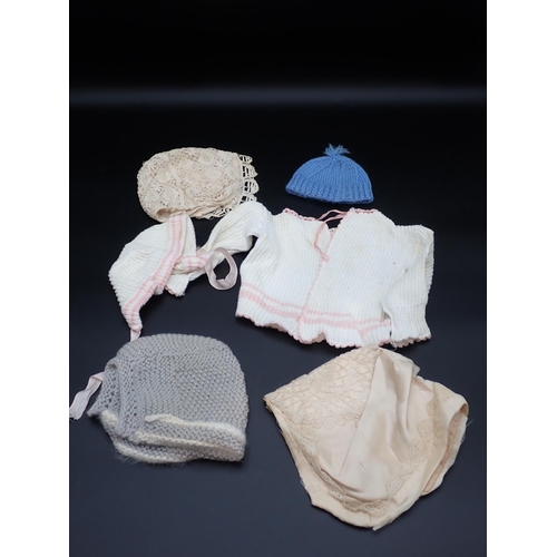 370 - A quantity of antique Doll's Clothes including lace and knitted woollen garments