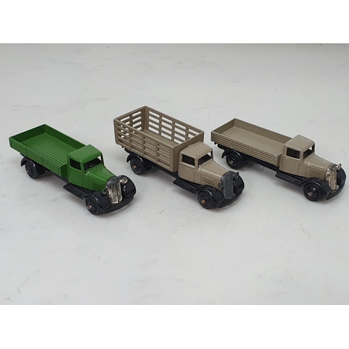 390 - An unboxed Dinky Toys 25/4 stone coloured Market Garden Wagon, 25a/4 stone coloured Wagon and a 25a/... 