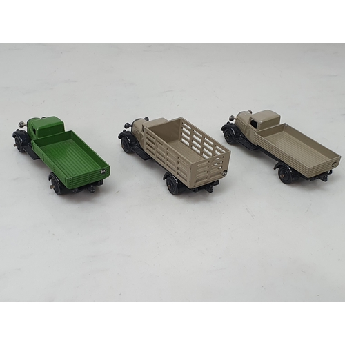 390 - An unboxed Dinky Toys 25/4 stone coloured Market Garden Wagon, 25a/4 stone coloured Wagon and a 25a/... 