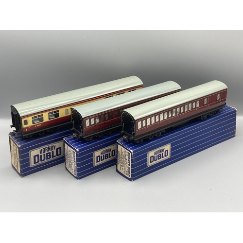 50 - Seven Hornby Dublo 3-rail Coaches comprising pair of D13, D14 Brake with over sticker box, pair D12,... 