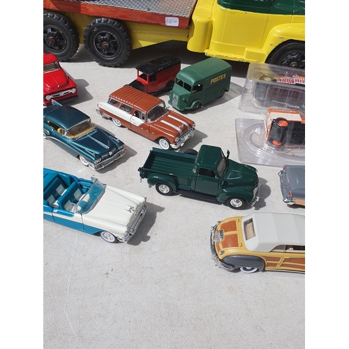 565 - A box of diecast Models including ERTL Case Road Grader, modern Vans and a tinplate flatbed Lorry