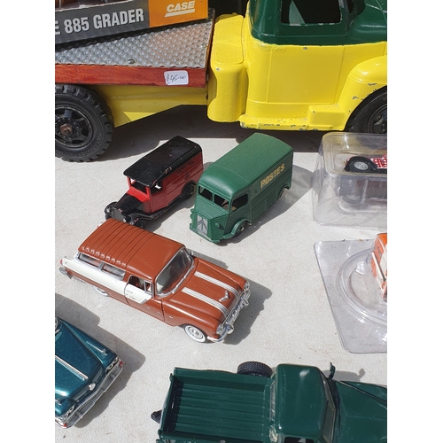 565 - A box of diecast Models including ERTL Case Road Grader, modern Vans and a tinplate flatbed Lorry