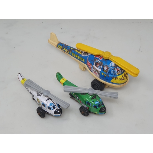 593 - Two Japanese tinplate Helicopters and a plastic and tinplate Helicopter