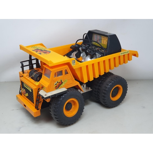 595 - A remote control CAT Dumper Truck, a battery operated Lorry, a Tonka Lorry and a tinplate Crane Lorr... 