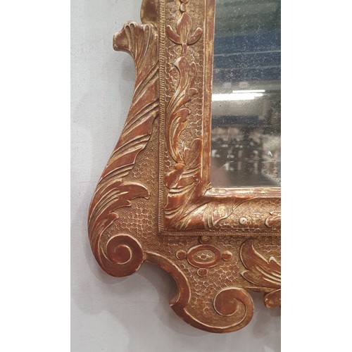 557 - A gilt framed Wall Mirror with elaborate scrolled surmount above the bevelled plate, 3ft 4in H (amen... 