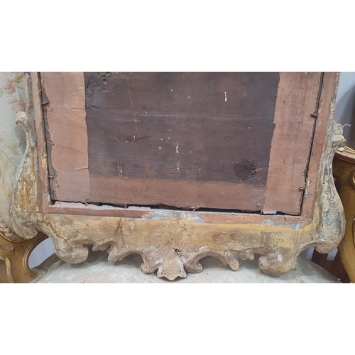 557 - A gilt framed Wall Mirror with elaborate scrolled surmount above the bevelled plate, 3ft 4in H (amen... 