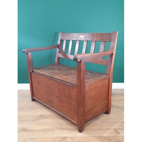 701 - An antique oak Box Settle with slat back rest on square supports, 2ft 9