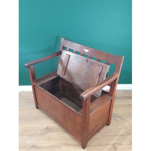 701 - An antique oak Box Settle with slat back rest on square supports, 2ft 9