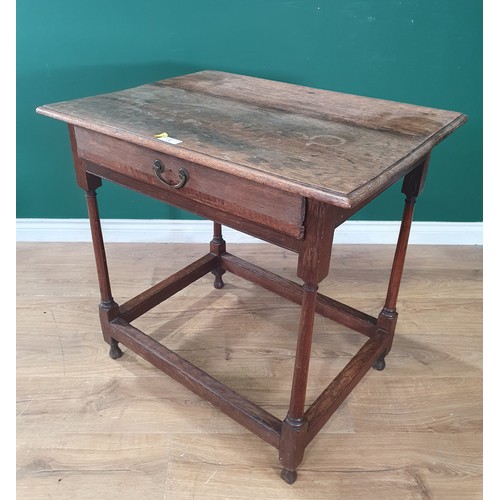 527 - An antique oak Side Table with single fitted drawer on turned supports and square stretchers and bun... 