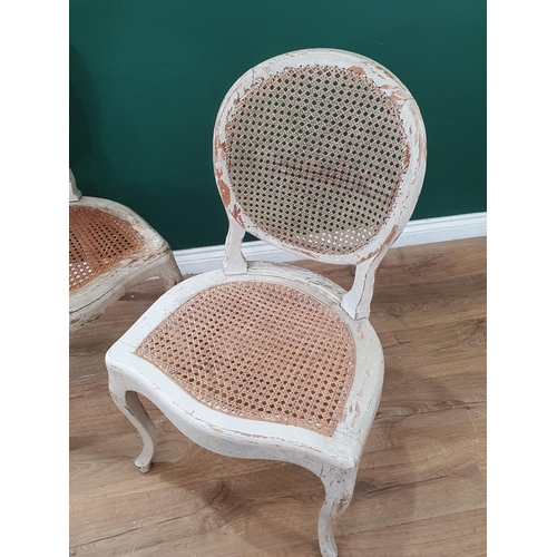 567 - A pair of white painted cane work Single Chairs. (R3).