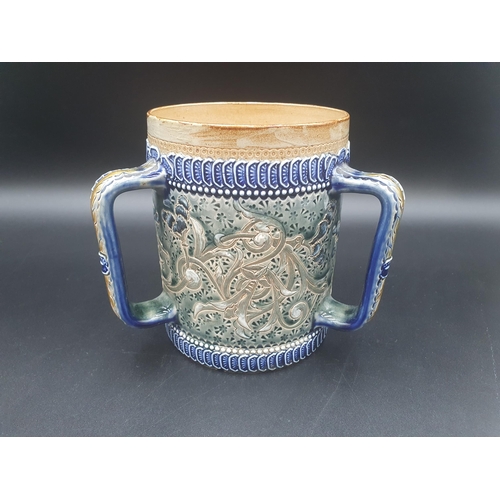 85 - A Doulton Lambeth stoneware three handled Tyg with incised floral design having blue/green glazes, 6... 