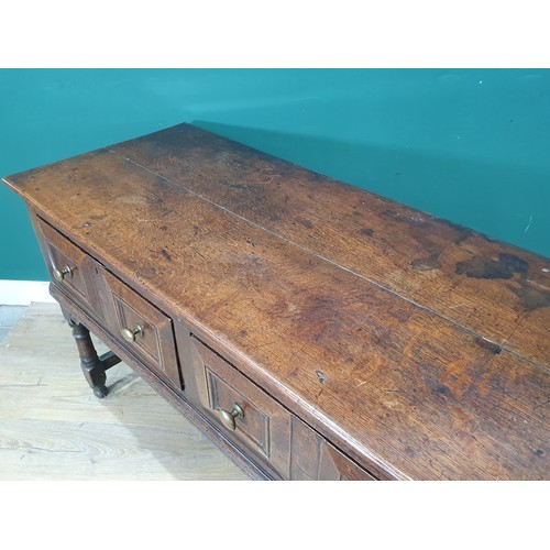 830 - A Charles II oak Dresser Base, fitted four moulded drawers on turned and squared supports and square... 