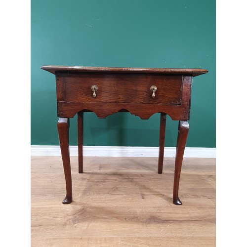 809 - A Georgian oak Lowboy with moulded top, with frieze drawer above a shaped frieze on slender cabriole... 