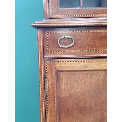 820 - An Edwardian mahogany inverted breakfront Bookcase with double domed top above an inlaid frieze of u... 