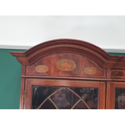 820 - An Edwardian mahogany inverted breakfront Bookcase with double domed top above an inlaid frieze of u... 