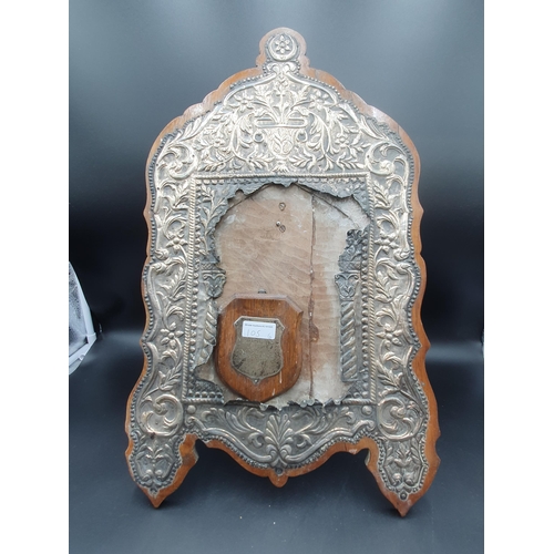 105 - A large Continental silver Frame with floral and leafage scroll embossing, mounted on wood, 20 x 13i... 