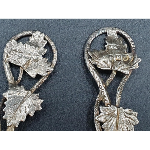 111 - A new pair of Victorian silver Spoons with fruiting vine embossed bell shape bowls, leafage and spir... 