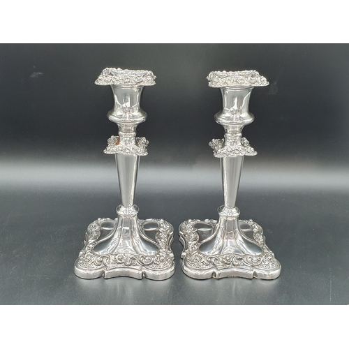 124 - A pair of Victorian plated Candlesticks with foliate friezes on shaped square bases, 8in