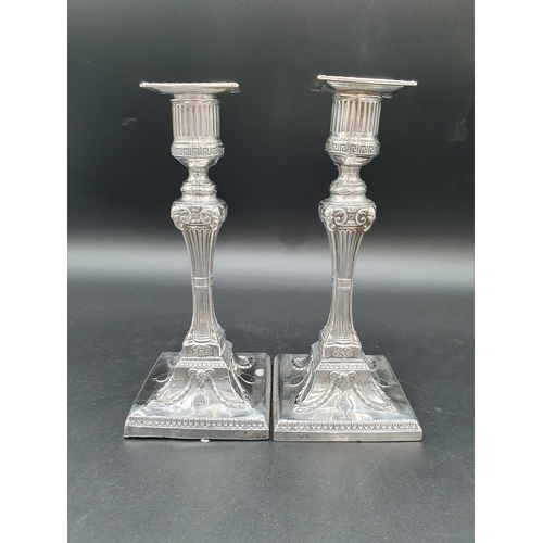 132 - A pair of Victorian silver Candlesticks having fluted columns with ram's head mask capitals, on squa... 