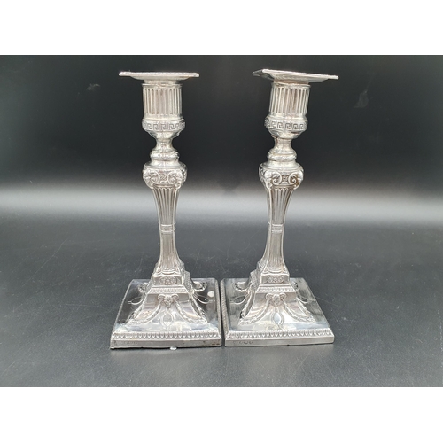 132 - A pair of Victorian silver Candlesticks having fluted columns with ram's head mask capitals, on squa... 